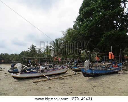 Anyer, Indonesia - June 26, 2018: Traditional Fishing Boats Lay Upon The Sand Beach.