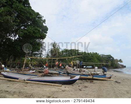 Anyer, Indonesia - June 26, 2018: Traditional Fishing Boats Lay Upon The Sand Beach.