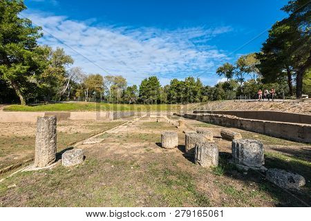 Olympia, Greece - October 31, 2017: Tourists On A Trip To The Ruins Of Archaeological Site Of Olympi