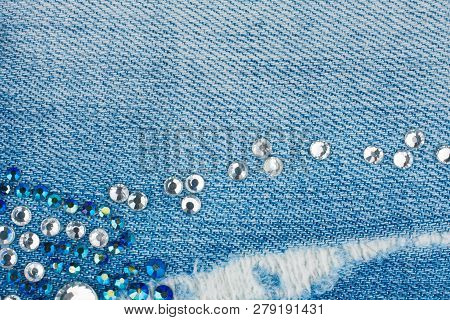 Light-blue Torn Denim With Blue And Silver Rhinestones, Background. Top View