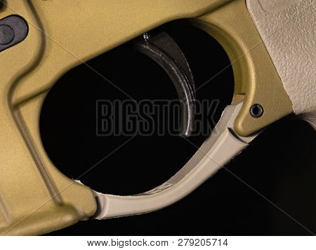 Ar-15 Trigger On A Bold Body And With A Dark Background