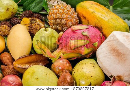 Summer Detox With Vegan Food. Assorted Thai Tropical Fruits On A Dark Wooden Rustic Background.