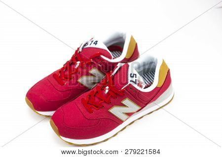 Boston, Ma, Usa, January 2019 - New Balance Nb 574 Red Athletic Shoes On Studio Background. New Bala