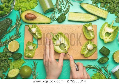 Healthy Green Vegan Cooking Ingredients. Flay-lay Of Female Hands Cutting Green Vegetables And Green