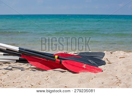 Boat Oars Lie On The Sand On The Beach By The Sea