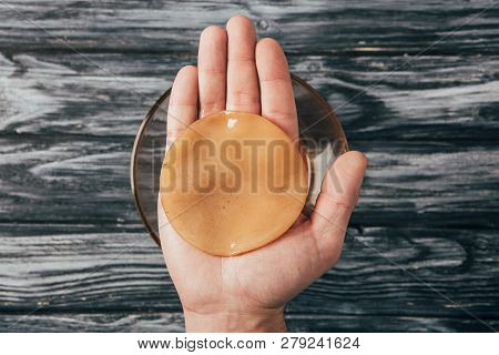 Top View Of Man Holding Kombucha Mushroom In Hands