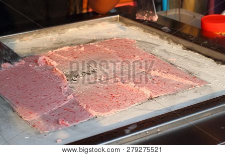 Cooking Cambodian Or Thail Stir-fried Ice Cream Rolls At Freeze Pan. Organic Natural Rolled Ice Crea