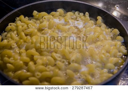 Pasta Is Cooked In A Black Cauldron Close Up, Home Made, Pasta Cooked In A Boiling Pot On The Stove 