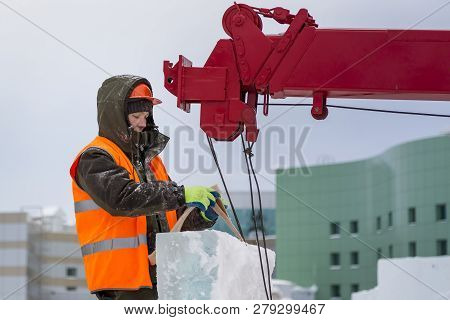 Slinger In An Orange Helmet On Unloading Ice Blocks
