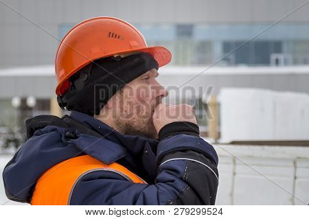 Slinger In An Orange Helmet With A Cigarette