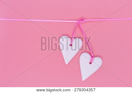 Two White Hearts Together On Pink Background. Holiday Concept For Wedding Or Valentine’s Day.