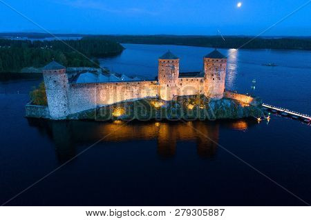 View Of The Ancient  Olavinlinna Fortress On A July Night (shooting From A Quadrocopter). Savonlinna