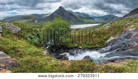 Beautiful Panorama Landscape Image Of Stream Flowing Over Rocks Near Llyn Ogwen In Snowdonia During 