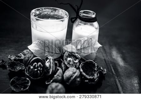 Close Up Of Akhrot Ka Dudh Or Walnut Milk On Wooden Surface With Raw Milk In  A Glass Bottle And Som