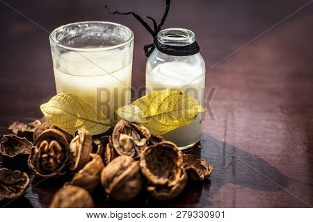 Close Up Of Akhrot Ka Dudh Or Walnut Milk On Wooden Surface With Raw Milk In  A Glass Bottle And Som