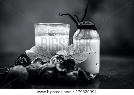 Close Up Of Akhrot Ka Dudh Or Walnut Milk On Wooden Surface With Raw Milk In  A Glass Bottle And Som