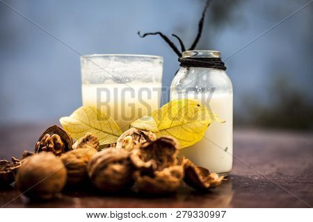 Close Up Of Akhrot Ka Dudh Or Walnut Milk On Wooden Surface With Raw Milk In  A Glass Bottle And Som