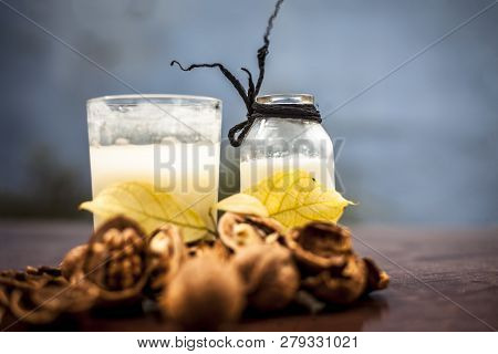 Close Up Of Akhrot Ka Dudh Or Walnut Milk On Wooden Surface With Raw Milk In  A Glass Bottle And Som