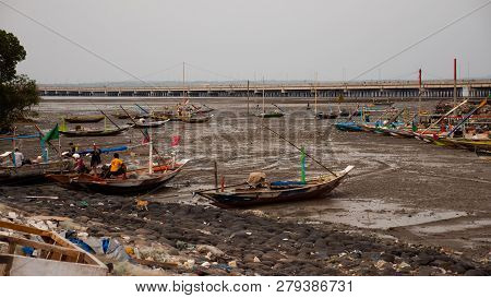 Harbor At Low Tide With Fishing Boats Waiting High Tide. Fishing Boats In Dry Harbour At Low Tide
