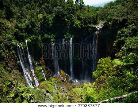 Waterfall Coban Sewu In Java, Indonesia. Waterfall In Tropical Forest By Drone Tumpak Sewu