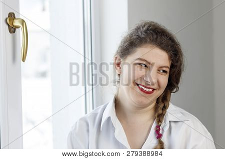 Young Woman 30 Years Old. Smiles At Us. Going To Repair The Handle On The Glass