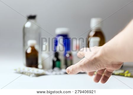 Right Hand Reaching For Meds With Selective Focus And Shallow Depth Of Field. Subjective First Perso
