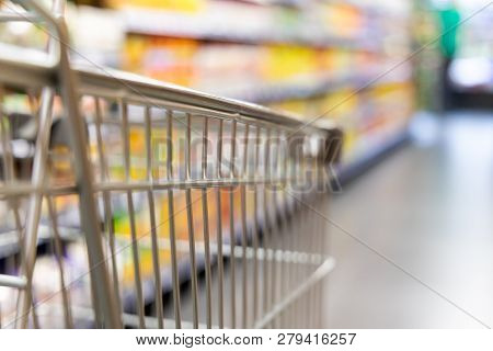 Shopping Trolley Cart With Shallow Dof Against Supermarket Aisle Background