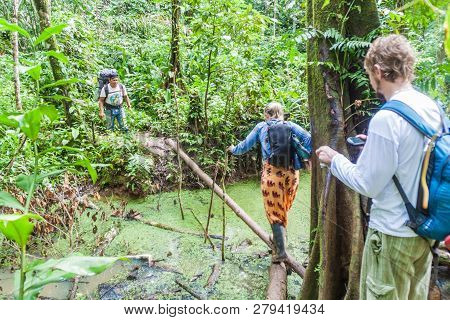 Madidi, Bolivia - May 8, 2105: Native Tour Guide And Tourists In A Jungle Of Madidi National Park, B