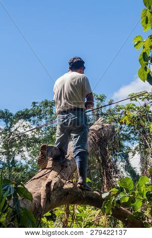 Madidi, Bolivia - May 8, 2105: Native Tour Guide Hunting In A Jungle Of Madidi National Park, Bolivi