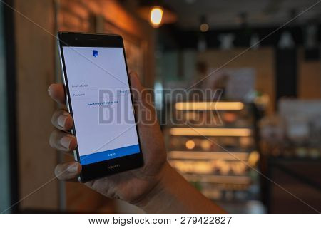 Chiang Mai, Thailand - June 09,2018: Man Holding Huawei With Paypal Apps On The Screen. Paypal Is An