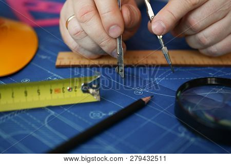 Male Hand Hold Compass. Engineering Blueprint Design For Buildings Of Blue Architecture Tools To Ach