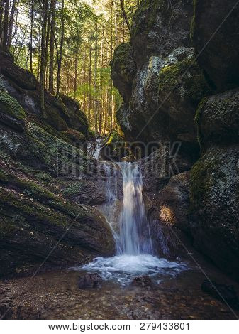Mountain Creek Waterfall Among Mossy Rocks Of The Seven Stairs Canyon In The Piatra Mare Mountain, T