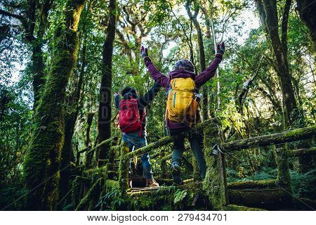Couples Traveling, Relax In Winter.enjoy Hiking Walking Travel To Study Nature In The Rainforest. At