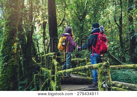 Couples Traveling, Relax In Winter. Walking Travel To Study Nature In The Rainforest. At The Angka, 