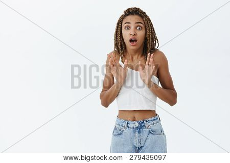 Portrait Of Shocked And Nervous Young African American Female Manager With Dreads In White Top Gaspi
