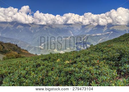 Beautiful Scenic Landscape Of Caucasus Mountain Ridge Covered With Range Of Cumulus Clouds On Sunny 