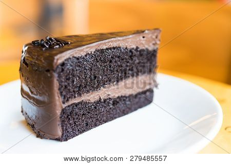 Chocolate Cakes On White Plate In Coffee Shop