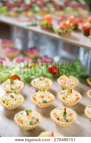 Delicious Tartlets Stuffed With Vegetable Salad On Buffet Table. Catering Concept