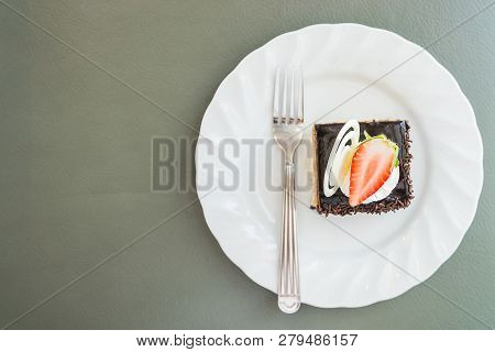 Top Of View Sweet Dessert Chocolate Cake With Strawberry Fruit On Top In White Plate - Selective Foc