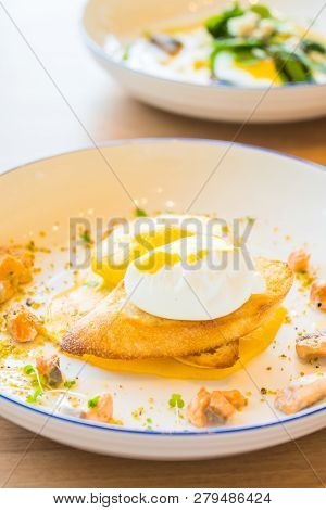 Egg Benedict With Salmon In White Plate For Breakfast