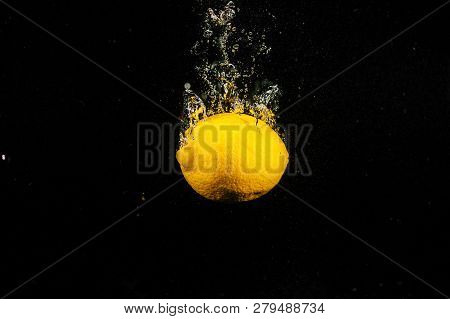 Juicy Lemon Falls In Water On Black Background
