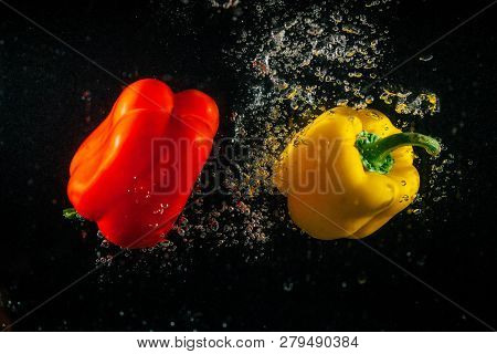 Red And White Pepper Make Bubbles Falling In Water