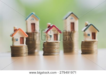 Mini House On Stack Of Coins,money And House,  Mortgage, Savings Money For Buy House And Loan To Bus