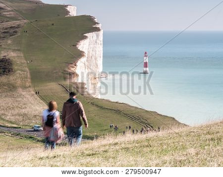 South Downs, Uk - 24 October 2019: A Young Couple Walking Over The South Downs Towards Beachy Head A