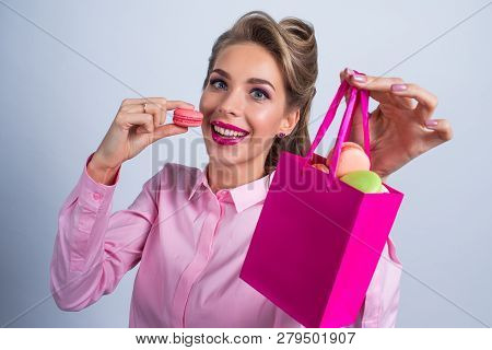 Funny Smiling Blond Woman Eating Colorful Macaroons