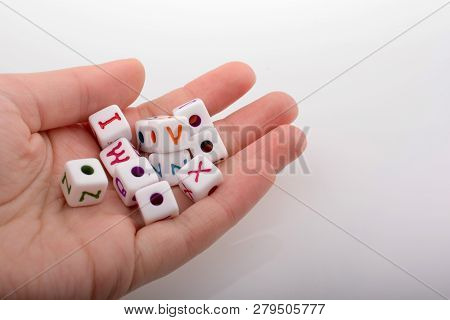 Colorful Alphabet Letter Cubes In Handon A White Background
