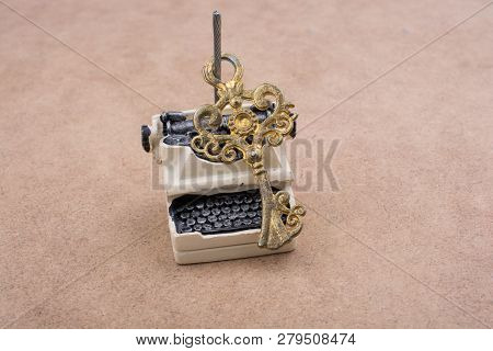 Retro Syled Tiny Typewriter Model On A White Background