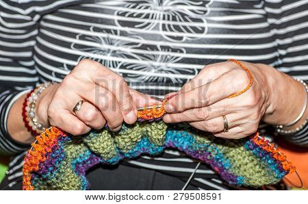 Needlework, Hands Of Old Woman Holding Knitting Needles And Multi Colored Wool For Woolwork Of Warm 