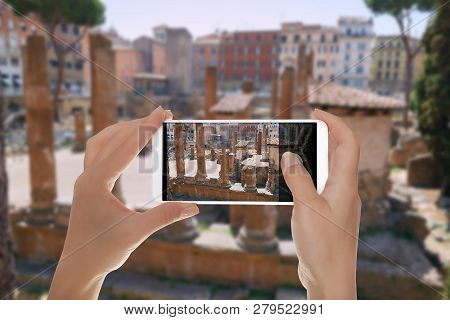 A Tourist Is Making A Photo Of Ancient Ruins On The Square Of Torre Argentino In Rome, Italy On A Mo