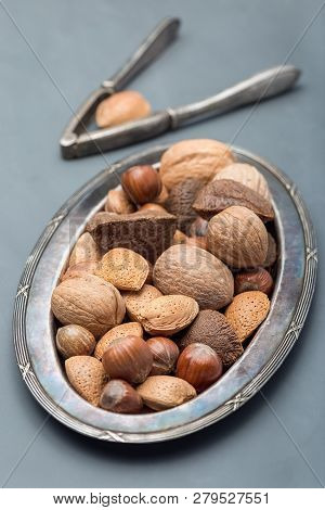 Different Kinds Of Nuts In The Shell: Hazelnut, Walnut, Almond And Brazil Nuts On The Plate With Nut